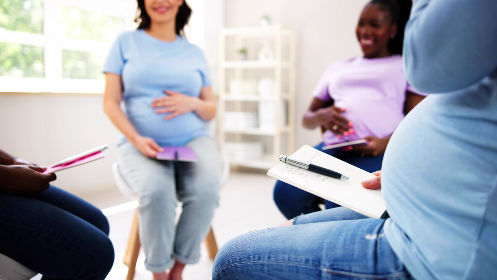pregnant women sitting in chairs in a circle at birth class